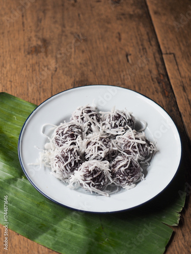 dish of Kanom Tom, Thai sweet coconut balls, on banana leaf