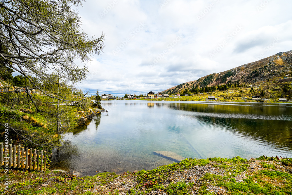 Fototapeta premium View of Lake Falkert in the Gurktal Alps and the surrounding landscape. Nature at a mountain lake in Carinthia. High mountain lake in Austria. 