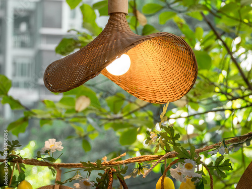 ilumminated lamp with straw shade hanging outdoor