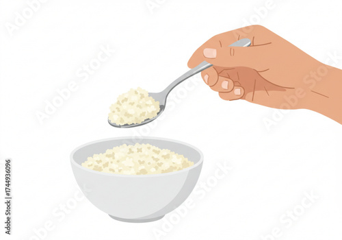 Hand holding spoon with cauliflower rice above a white bowl  