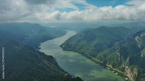 Aerial view on Danube river and mountains under clouds