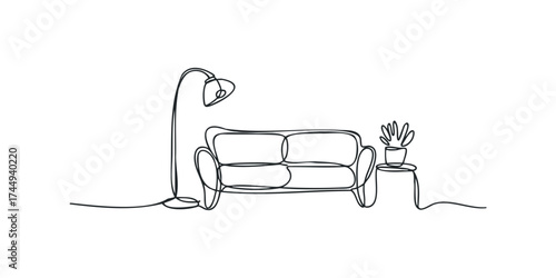 Continuous line drawing of a modern sofa and lamp