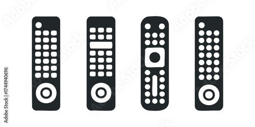 Four Black Remote Controls with White Buttons and Circles