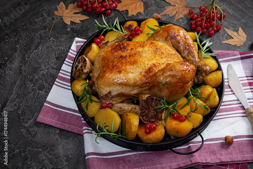 Roasted chicken with potatoes. Autumn decoration Thanksgiving day. Baked whole chicken.