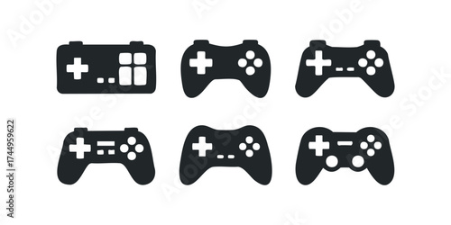 Collection of black game controllers on a white background