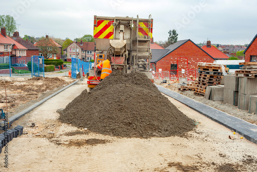 Mixer truck delivered concrete on construction site and unloaded on ground