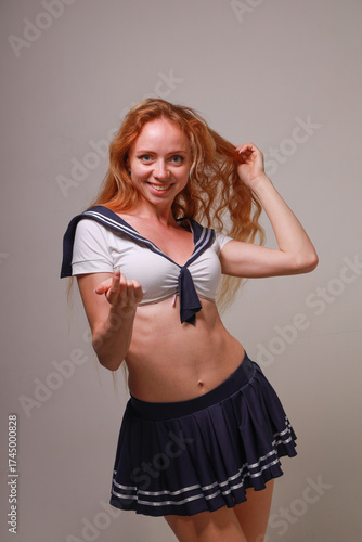 Beautiful sexy red-haired girl in a sailor costume