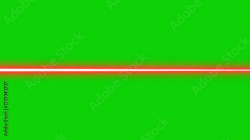 Dynamic red laser beam streaks across vibrant green screen background, perfect for sci fi action edits and futuristic visual effects