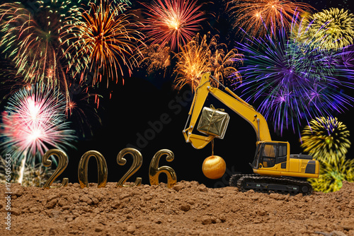 Concept happy new year 2026, crawler excavator with lift up bucket gift in Christmas festival.on fireworks backgrounds