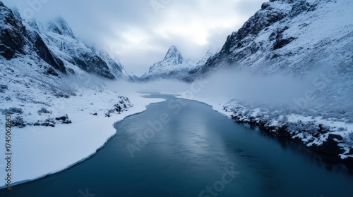 Wallpaper Mural A serene winter landscape featuring a winding river bordered by snow-covered mountains, shrouded in mist, Ideal for travel brochures, nature websites, and winter-themed projects, Torontodigital.ca