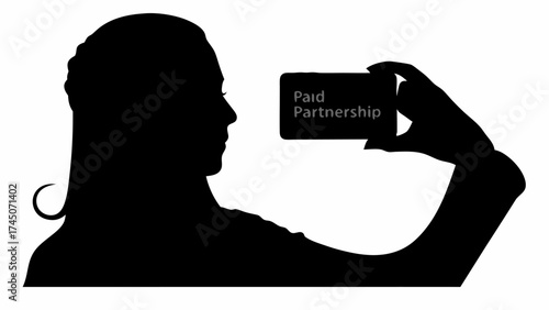 Silhouette of woman holding a card that reads paid partnership in her hand in black and white