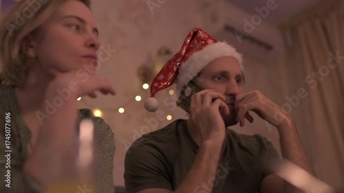 A happy married couple celebrates New Year and Christmas in a cozy apartment