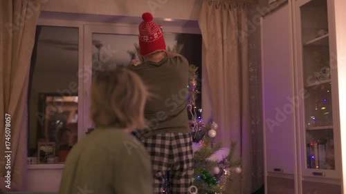 A happy married couple celebrates New Year and Christmas in a cozy apartment