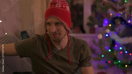 A happy married couple celebrates New Year and Christmas in a cozy apartment