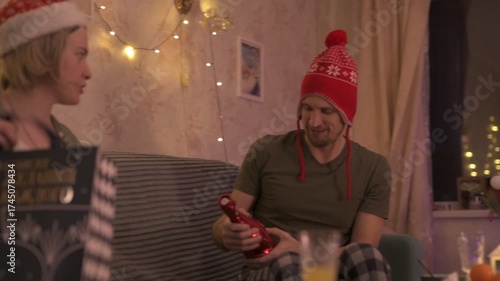 A happy married couple celebrates New Year and Christmas in a cozy apartment