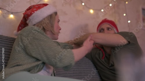 A happy married couple celebrates New Year and Christmas in a cozy apartment