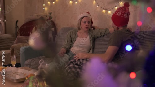 A happy married couple celebrates New Year and Christmas in a cozy apartment