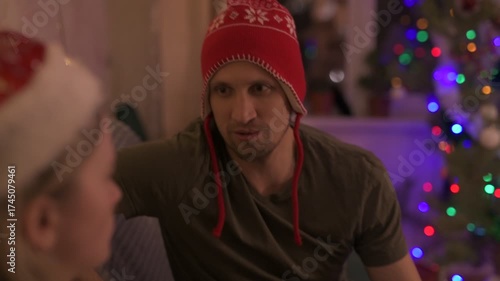 A happy married couple celebrates New Year and Christmas in a cozy apartment