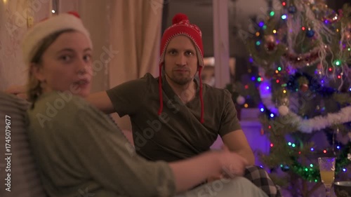 A happy married couple celebrates New Year and Christmas in a cozy apartment