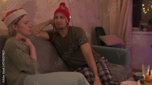 A happy married couple celebrates New Year and Christmas in a cozy apartment