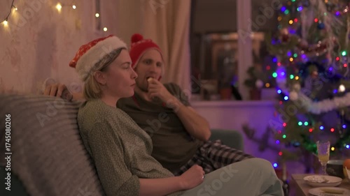 A happy married couple celebrates New Year and Christmas in a cozy apartment