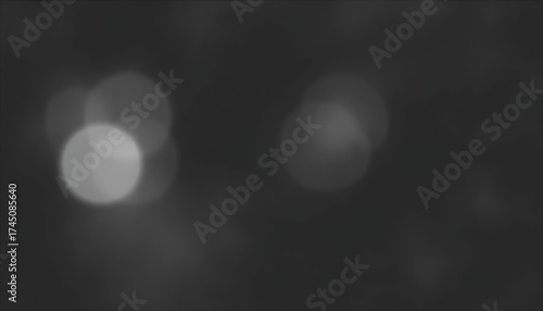Out of focus monochrome image showing light circles in a dark and blurry background scene view