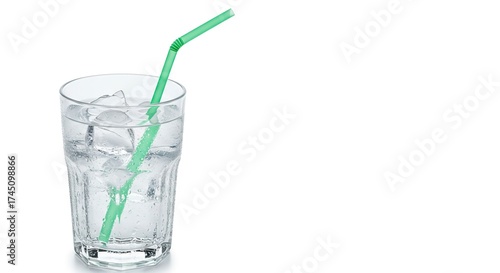 A faceted glass filled with ice water  a bendy green straw on a white background