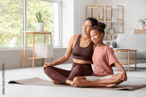 African-American mother with her teenage daughter hugging on yoga mat at home Free Download African-American mother with her teenage daughter hugging on yoga mat at home - GFXLoad
