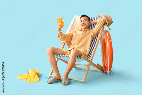 Young Asian man with cockta...