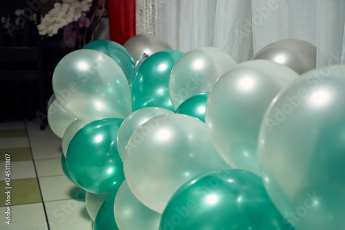 Close-up of inflatable balloons in green tones at a birthday party