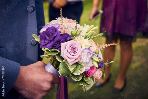 Close-up of the bride's wedding bouquet in purple tones