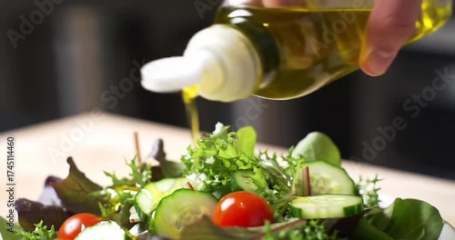 Wallpaper Mural Fresh salad preparation with olive oil drizzling action Torontodigital.ca