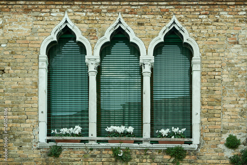 Arched windows on a vintage brick wall in Venice.