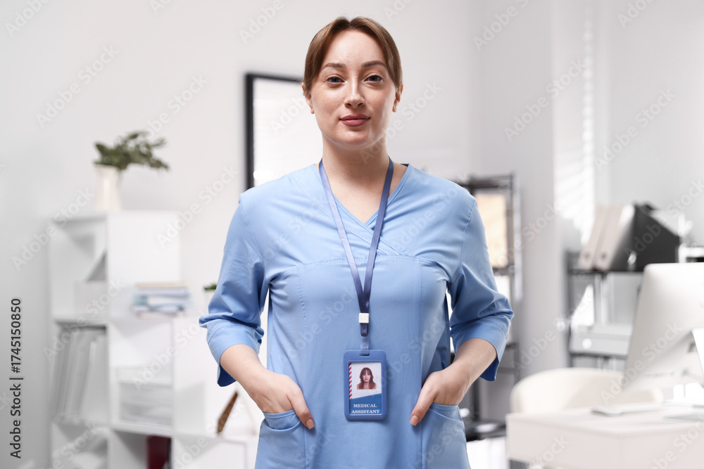 Fototapeta premium Professional nurse with badge in office. Medical worker