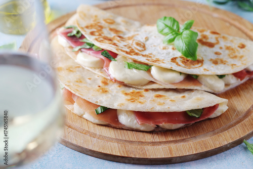 Traditional Italian dish Piadina romagnola - flat bread with mozarella and proscuitto	