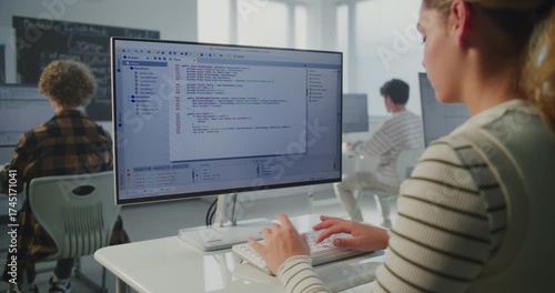 Girl at Institute Doing Practical Coding Project. In Game Dev Workshop, Young Woman Typing Program Code on Monitor. Concept Modern Education, Studying Computer Science, Future Technology Skills.