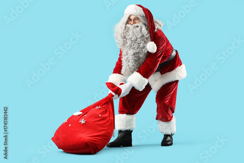Santa claus in red suit lif...