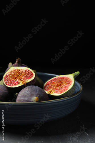 Fresh ripe figs in a dark b...