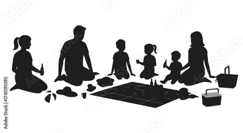 Family enjoying a picnic together in a park silhouetted against white