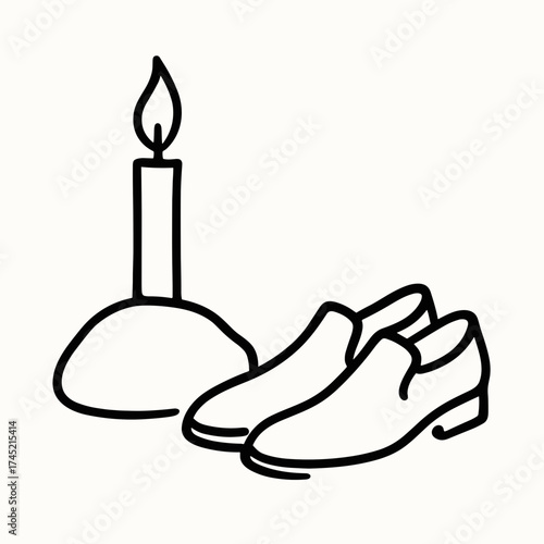Candle and shoes near stone
