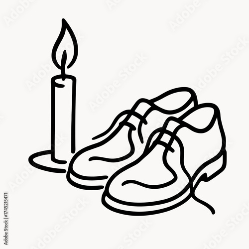 Candle burning beside old shoes