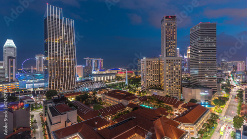 Evening panorama with Marina Bay area and skyscrapers city skyline aerial day to night timelapse.