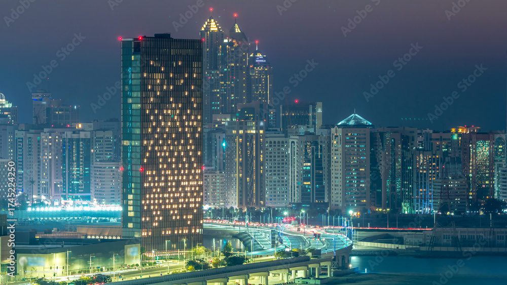 Obraz premium Buildings on Al Reem island in Abu Dhabi day to night timelapse from above.