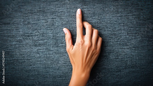 Hand pointing on textured fabric background
