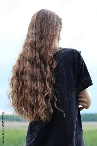 back view of a young woman with long hair