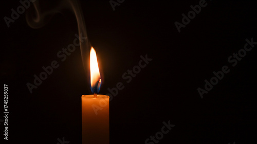 Peaceful candle flame glows in the darkness for remembrance