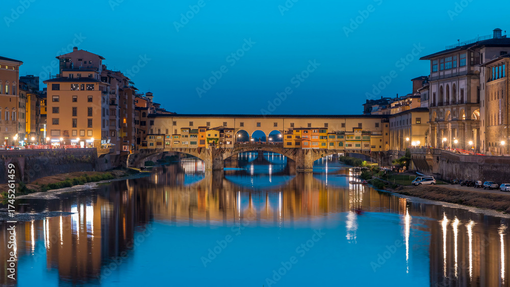 Naklejka premium River Arno and famous bridge Ponte Vecchio day to night timelapse after sunset in Florence, Tuscany, Italy