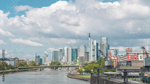 Hyperlapse of Frankfurt's Main Iron Footbridge against the financial district skyscrapers skyline on a sunny day with clouds timelapse. Frankfurt, Germany