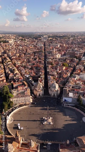 Drone panoramic view of Rome showcasing Santa Maria dei Miracoli and Santa Maria in Montesanto twin churches on Piazza del Popolo, iconic cinematic landmarks of the Eternal City