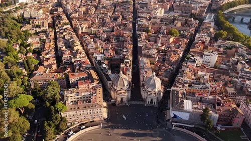 Drone cinematic view of Rome’s Piazza del Popolo with the twin baroque churches Santa Maria in Montesanto and Santa Maria dei Miracoli, iconic film setting and symbol of Roman heritage.